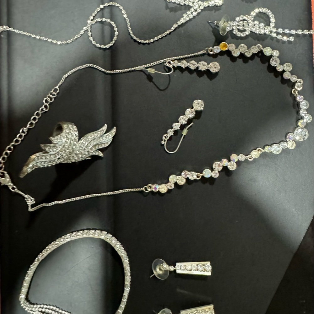 Bridal jewelry, one bracelet, two necklaces, two pairs of earrings and one ring.